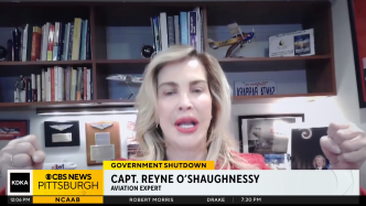 A woman identified as Capt. Reyne O'Shaughnessy, aviation expert, speaks during a CBS News Pittsburgh segment on government shutdown, with bookshelves and aviation memorabilia in the background.